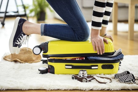 Woman Packing for A Vacation Overseas