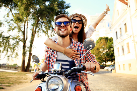 couple in love riding a motorbike abroad