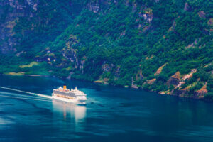 Breathtaking view of Sunnylvsfjorden fjord and cruise ship, near Geiranger village in western Norway.