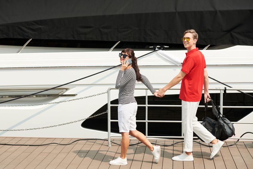 A young couple getting ready to board their first crewed yacht.